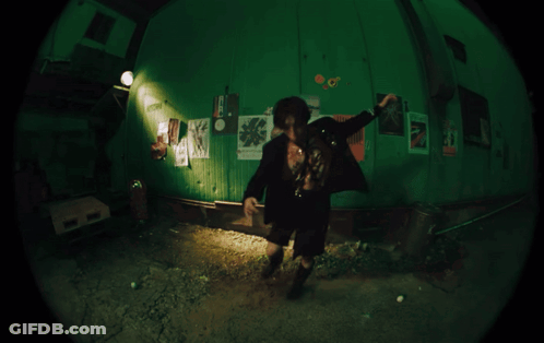 Fisheye Man In Room With Poster Saying A GIF