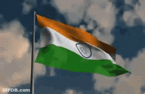 Flag Waving In Wind Against Cloudy Sky GIF
