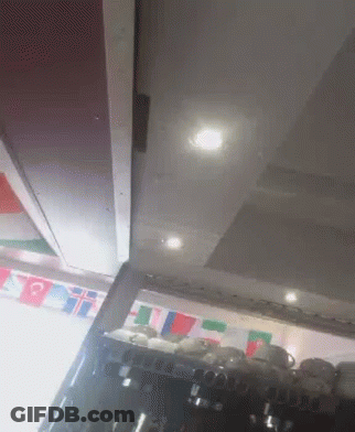 Flags Hanging Above Coffee Machine GIF