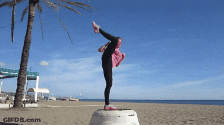 Flexible Woman Does One Leg Standing While Kicking GIF