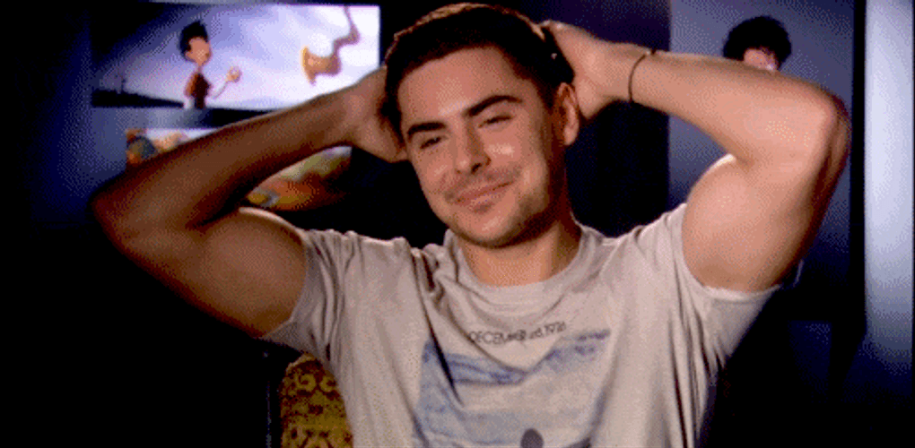 Flexing Zac Efron Satisfied GIF