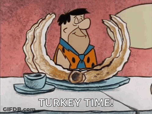 Flintstone Sitting At Table With Turkey Time Sign GIF