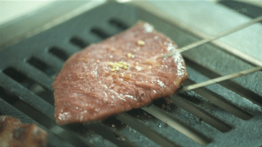 Flipping A Slice Of Quality Meat GIF