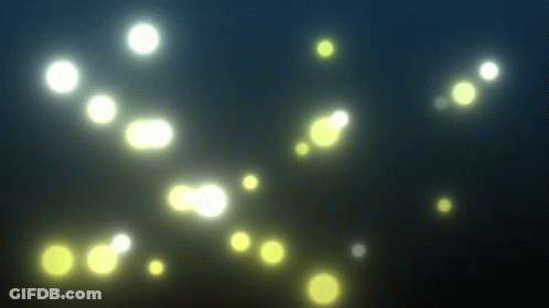 Floating Yellow Lights In Dark GIF