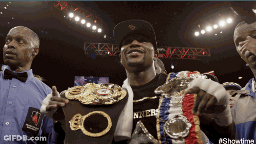 Floyd Mayweather Showcasing Championship Belts GIF