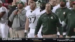 Football Coach Standing Before Players GIF