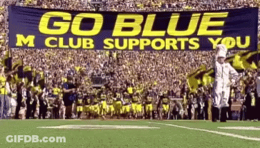 Football Field With Go Blue M Club Supports You Banner GIF