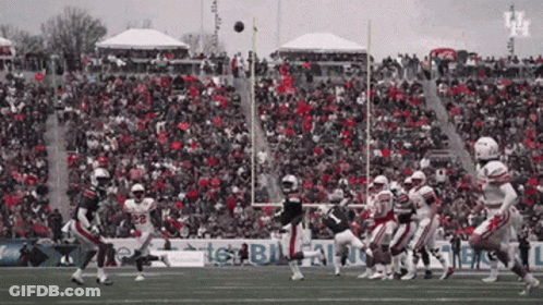 Football Game In Front Of Crowd With Texas Sign GIF