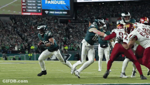 Football Game In Front Of FanDuel Scoreboard GIF