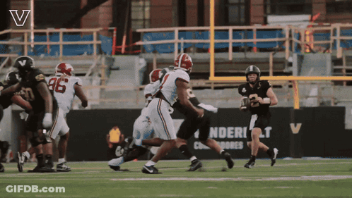 Football Game In Front Of Sign Saying Ndert GIF