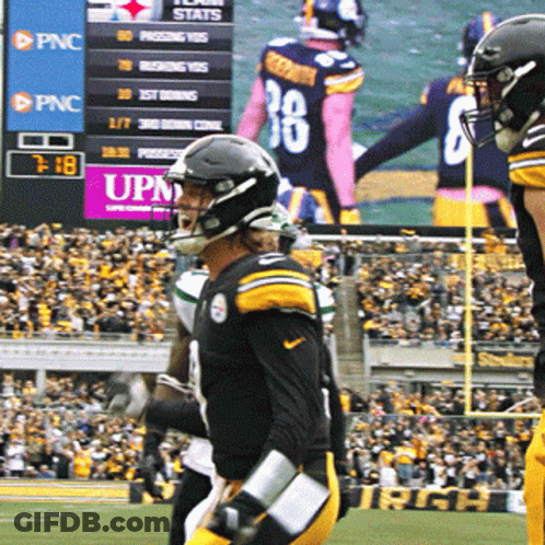 Football Game In Front Of UPNC Sign GIF