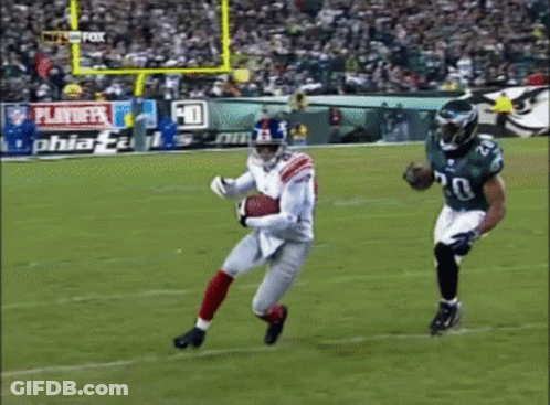 Football Game Played In Front Of Playoff Sign GIF