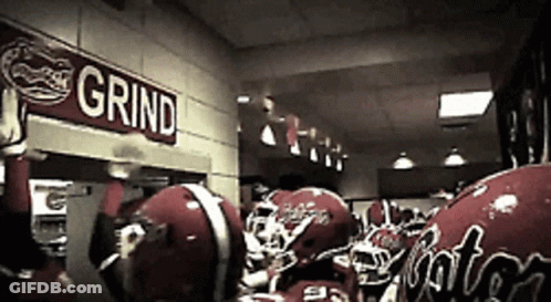 Football Helmets Lined Up Under Grind Sign GIF