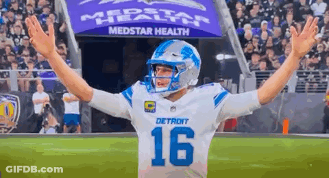 Football Player Arms Outstretched On Field GIF