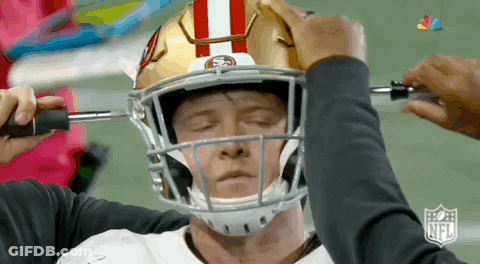 Football Player Being Adjusted By Person GIF