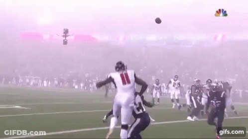 Football Player Catching Ball With Smoke From Stands GIF