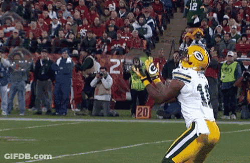 Football Player Catching Pass In Front Of Crowd Sign Saying 20 GIF