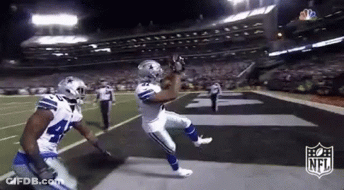 Football Player Catching Pass While Another Watches GIF