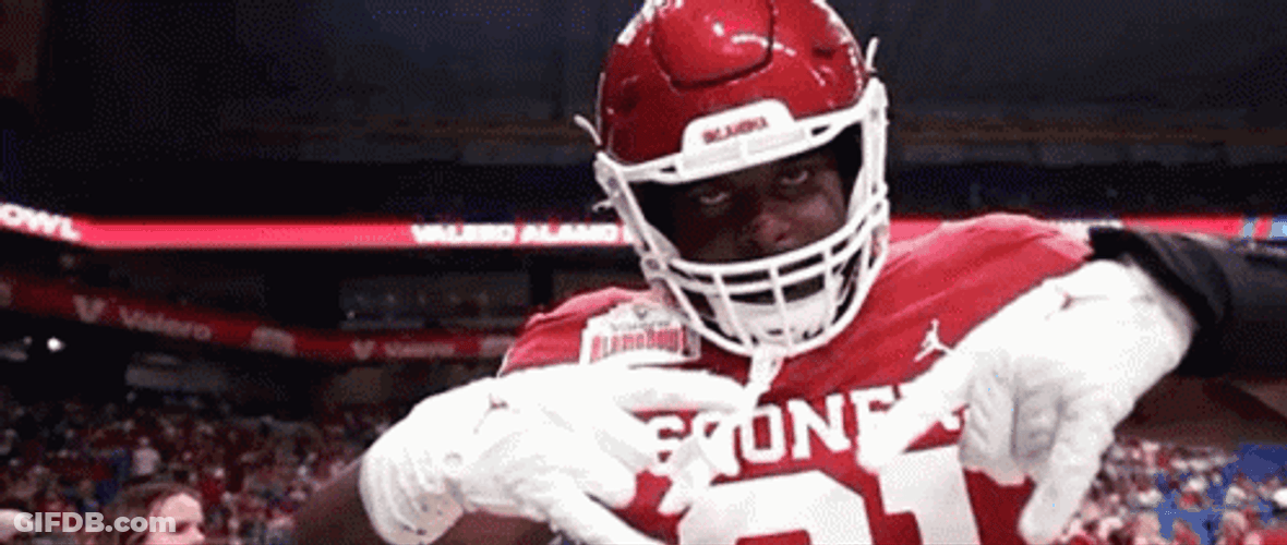 Football Player Doing Hook Em SIgn GIF