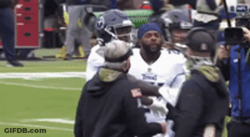 Football Player Helped Off Field By Nurse GIF