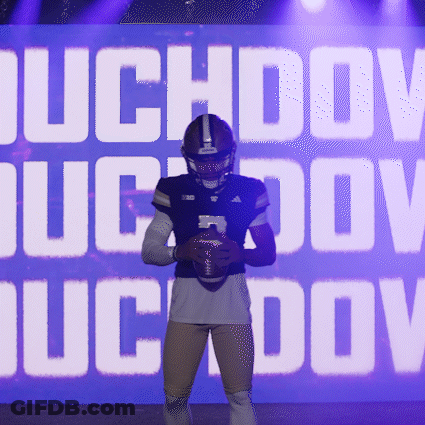 Football Player Holding Ball In Front Of Duchov Sign GIF