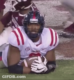 Football Player Holding Football On Field GIF