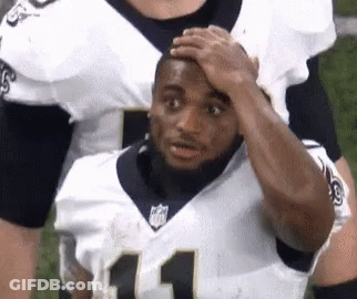 Football Player Holding Hand To Forehead On Field GIF