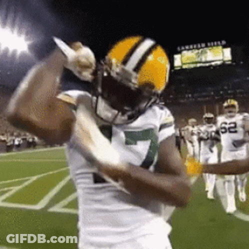 Football Player Holding Knife On Field GIF