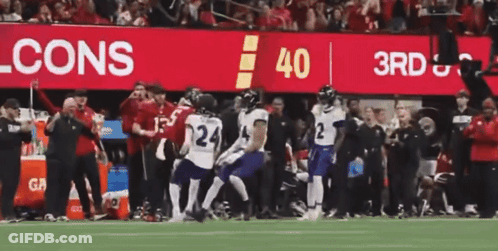 Football Player Holding Red Ball With Letter G GIF
