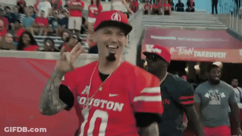 Football Player Holding Red Flag With Letter T GIF