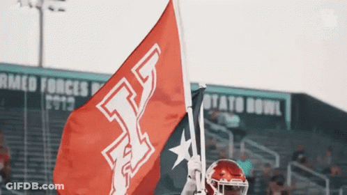 Football Player Holding Red Flag With Letter T GIF