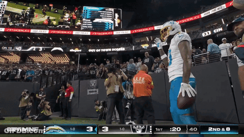 Football Player Holds Ball In Front Of ESPN MNF Screen GIF