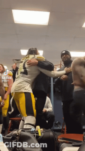 Football Player Hugging Another Player In Locker Room GIF