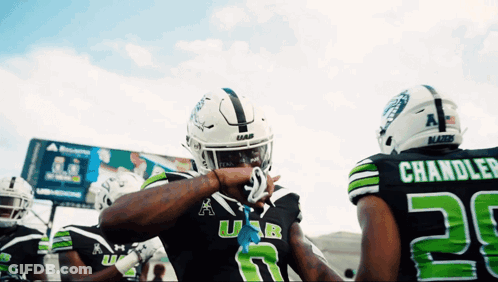 Football Player In Black And Green Uniform Number 28 GIF