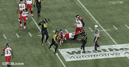 Football Player In Black Jersey With Yellow Stripes GIF