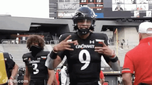 Football Player In Black Uniform Number 9 Giving Peace Sign GIF