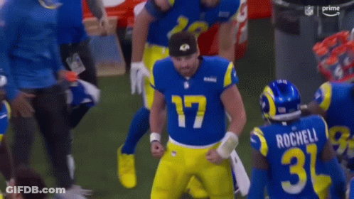 Football Player In Blue And Yellow Uniform Holding Helmet GIF