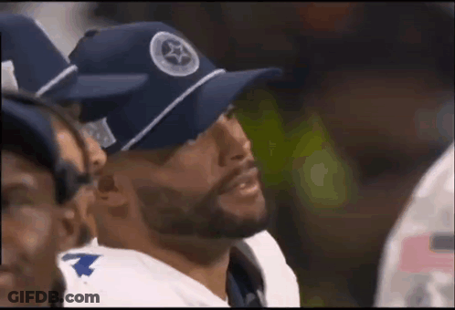 Football Player In Blue Hat Sitting In Huddle GIF