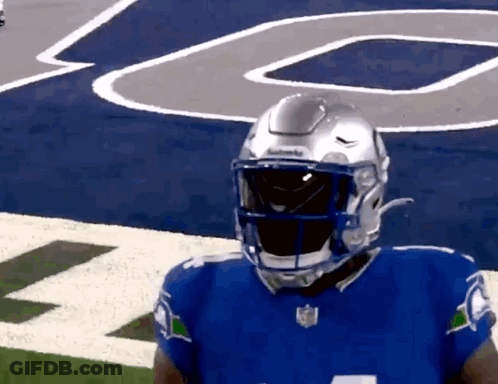 Football Player In Blue Jersey And Silver Helmet GIF