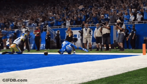 Football Player In Blue Jersey Number 22 Laying On Field GIF