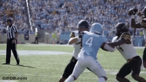 Football Player In Blue Jersey Number 4 Tackled By Referee GIF