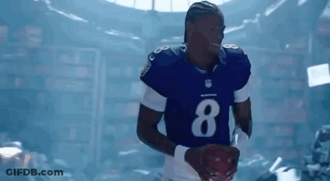 Football Player In Blue Uniform Holding Football GIF