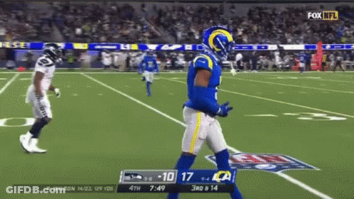 Football Player In Blue Uniform Walking On Field GIF