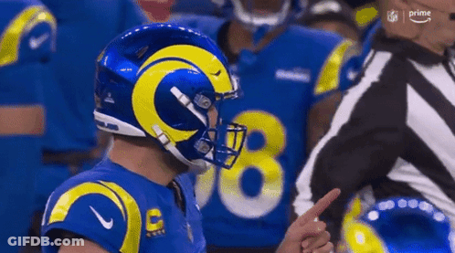 Football Player In Blue Yellow Helmet Pointing At Referee GIF