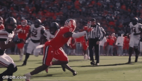 Football Player In Front Of Crowd With Goal Post GIF