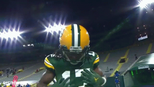 Football Player In Green And Yellow Uniform Number 12 GIF
