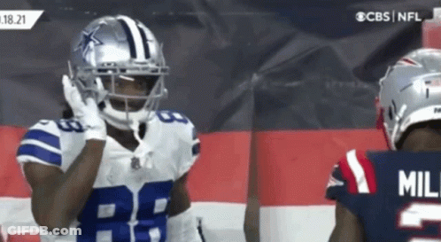 Football Player In Helmet 28 Next To Player In Jersey GIF