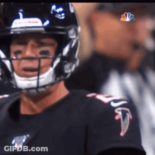 Football Player In Helmet And Black Shirt Before Referee GIF