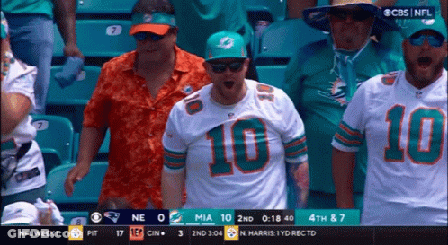 Football Player In Helmet And Gloves Covering Mouth GIF