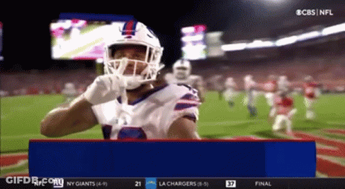Football Player In Helmet And Gloves Standing On Field GIF